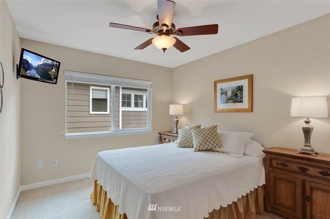 17112 164th Way Southeast Renton, WA 98058 - Photo 28 of 35 a bedroom with a bed and a chandelier