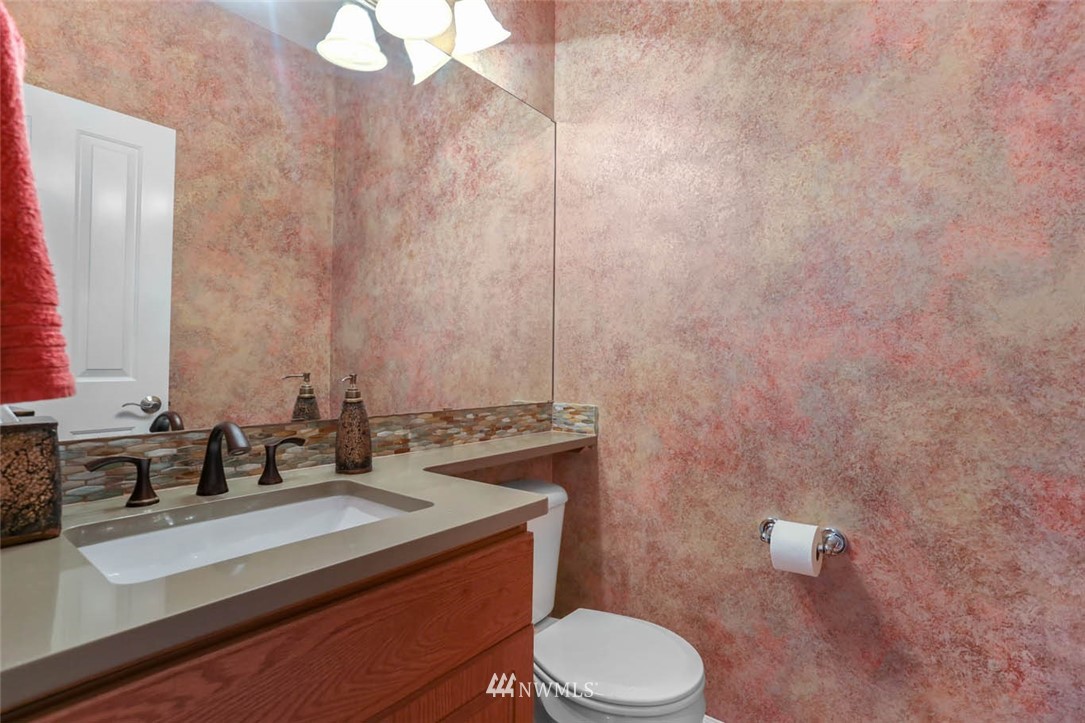 17112 164th Way Southeast Renton, WA 98058 - Photo 9 of 35 a bathroom with a sink a toilet and mirror