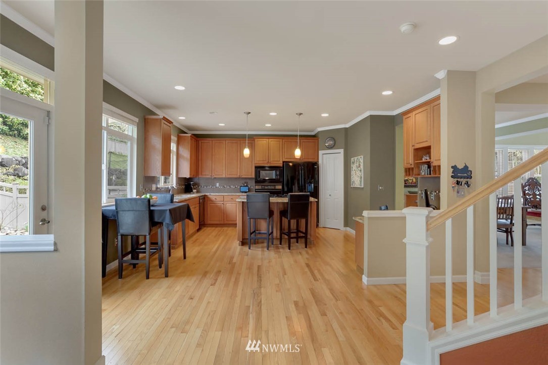 17112 164th Way Southeast Renton, WA 98058 - Photo 10 of 35 a living room with furniture and kitchen view with a large window