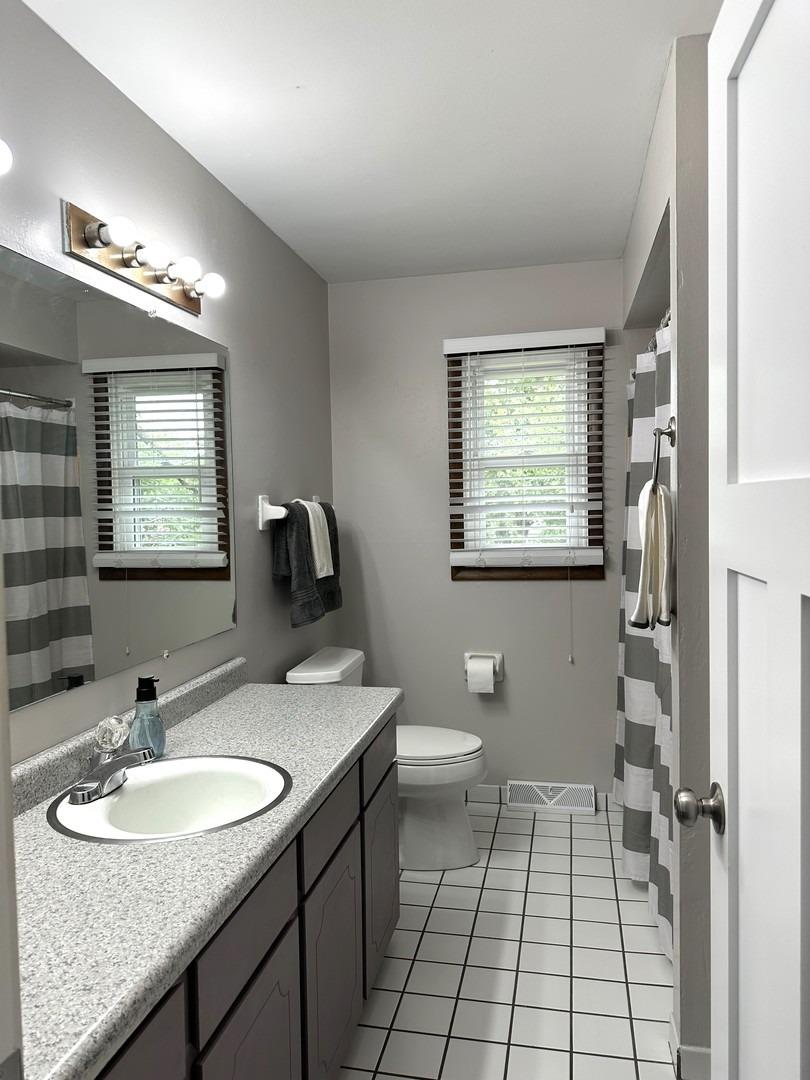 8693 Durbin Lane Crown Point, IN 46307 - Photo 14 of 18 a bathroom with a sink toilet and mirror