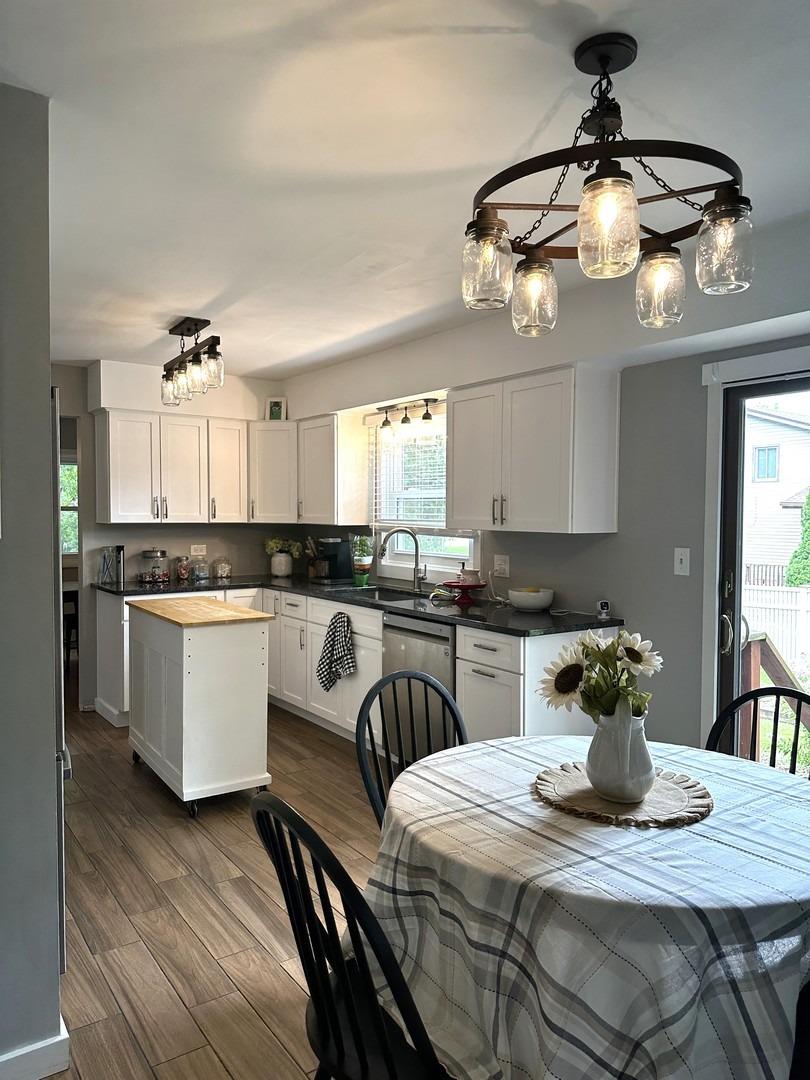 8693 Durbin Lane Crown Point, IN 46307 - Photo 7 of 18 a kitchen with a table chairs and white cabinets