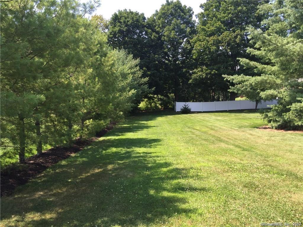 a view of a swimming pool with an outdoor seating and a forest