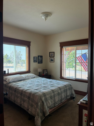 581 South 700 East Spring City, UT 84662 - Photo 18 of 42 Carpeted room featuring multiple windows with wood trim and horizontal blinds