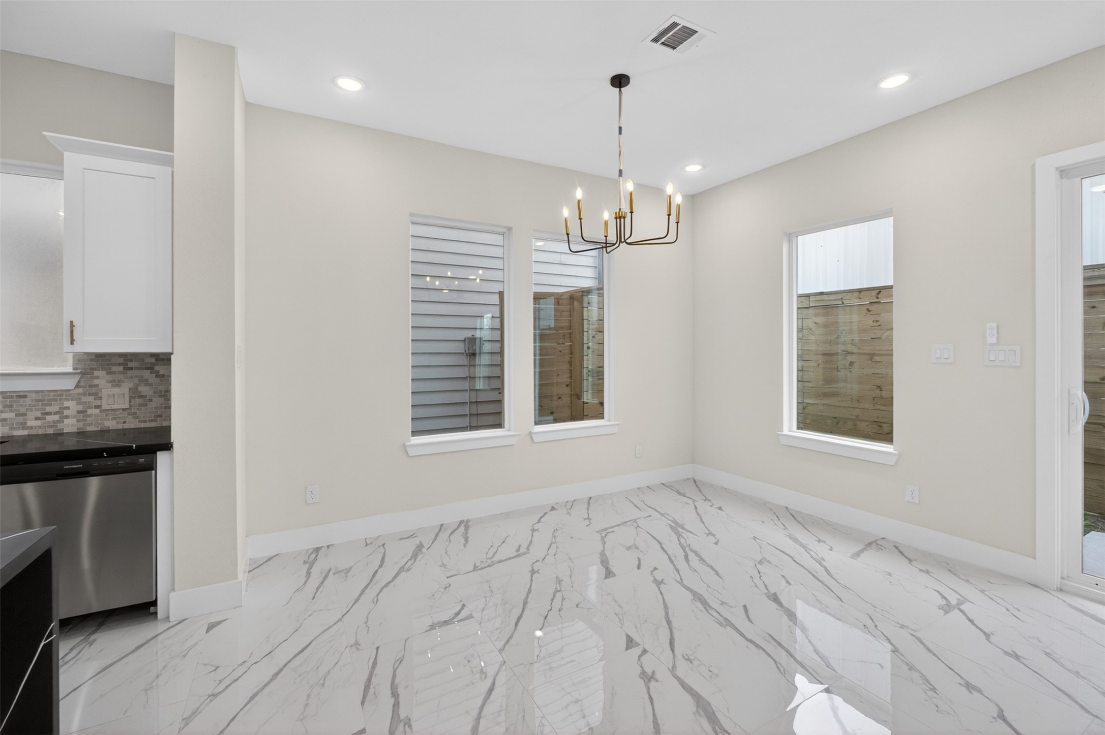 5906 St Augustine Street, Unit F Houston, TX 77021 - Photo 9 of 34 Alternate dining view with a chandelier and natural light from multiple windows.