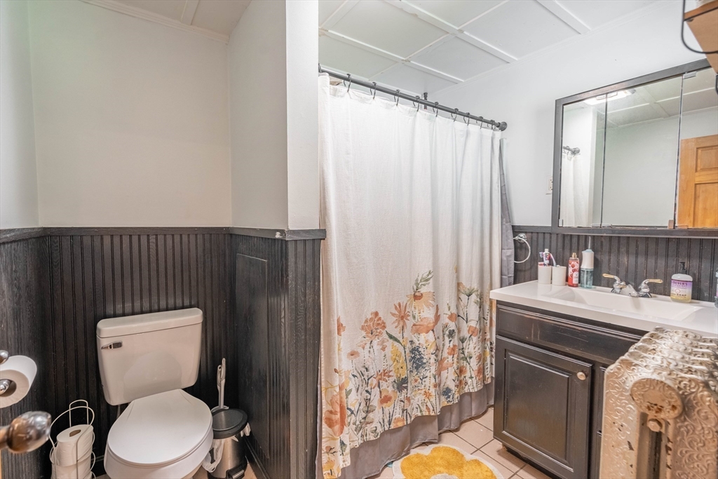 4 Walnut Street Brookfield, MA 01506 - Photo 12 of 33 a bathroom with a sink a toilet and shower curtain
