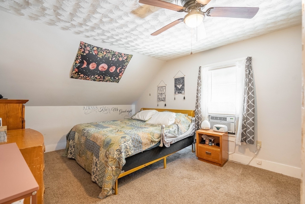 4 Walnut Street Brookfield, MA 01506 - Photo 17 of 33 a spacious bedroom with a bed and a chandelier
