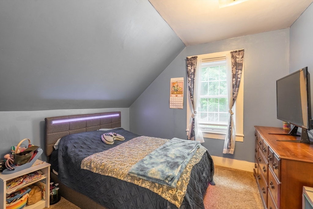 4 Walnut Street Brookfield, MA 01506 - Photo 21 of 33 a bedroom with a bed and a flat tv screen on a dresser