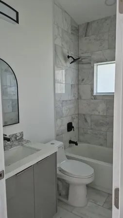 a bathroom with a toilet a sink and shower