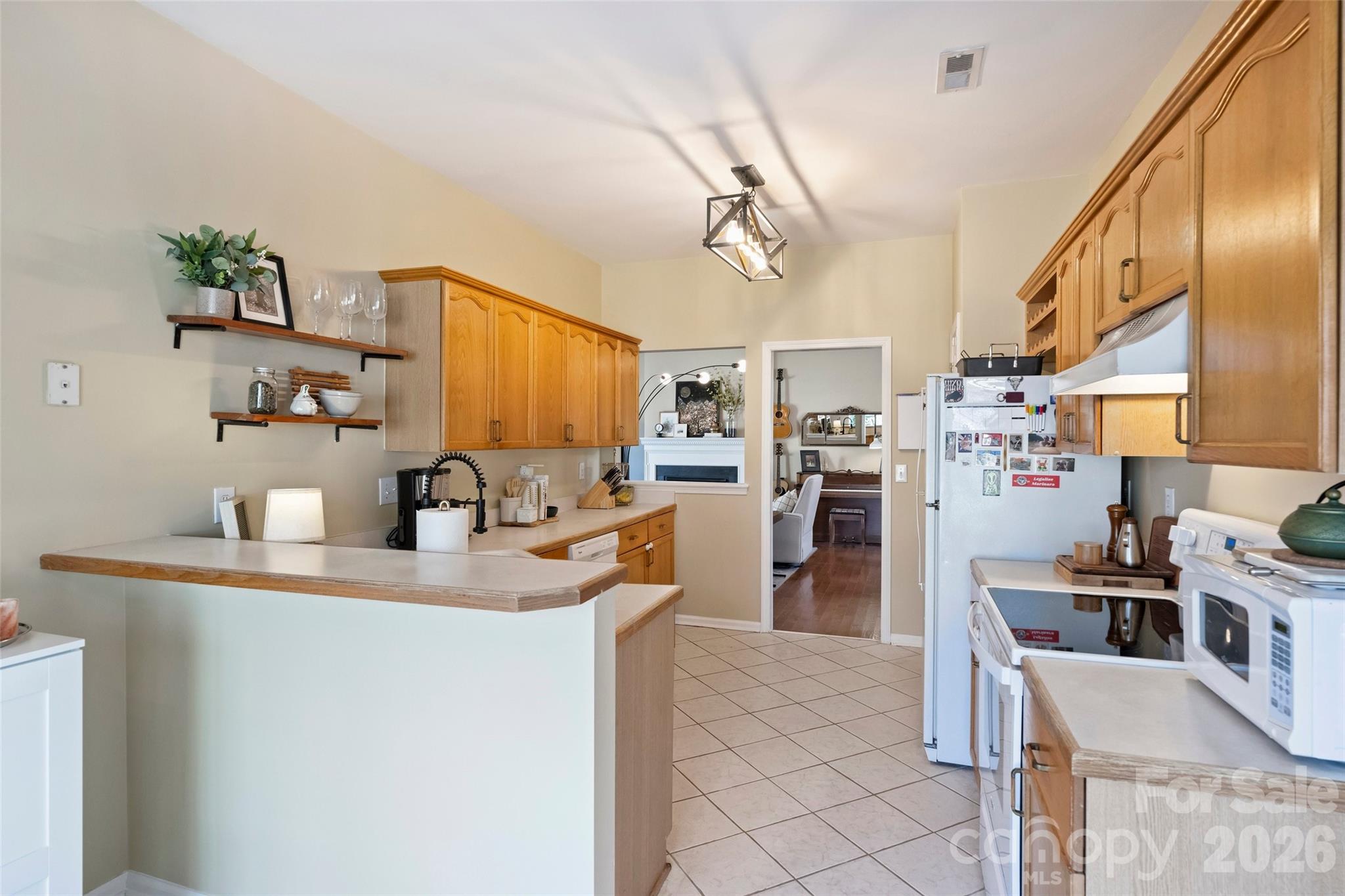 15346 Yarmouth Road Mint Hill, NC 28227 - Photo 15 of 43 a kitchen with refrigerator cabinets and wooden floor