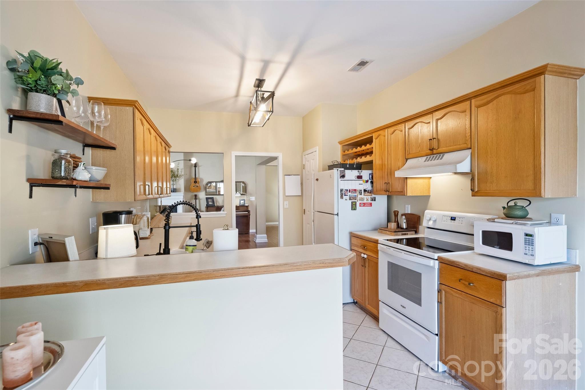 15346 Yarmouth Road Mint Hill, NC 28227 - Photo 16 of 43 a kitchen with stainless steel appliances granite countertop a stove a sink dishwasher and microwave with wooden floor
