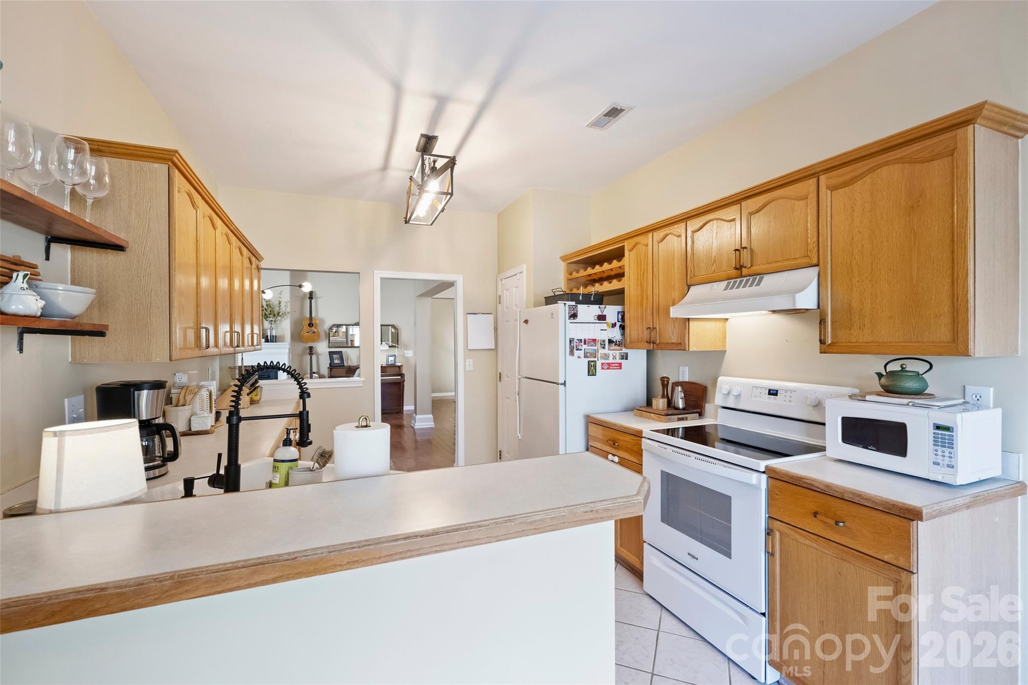 15346 Yarmouth Road Mint Hill, NC 28227 - Photo 17 of 43 a kitchen with kitchen island a sink stove and refrigerator