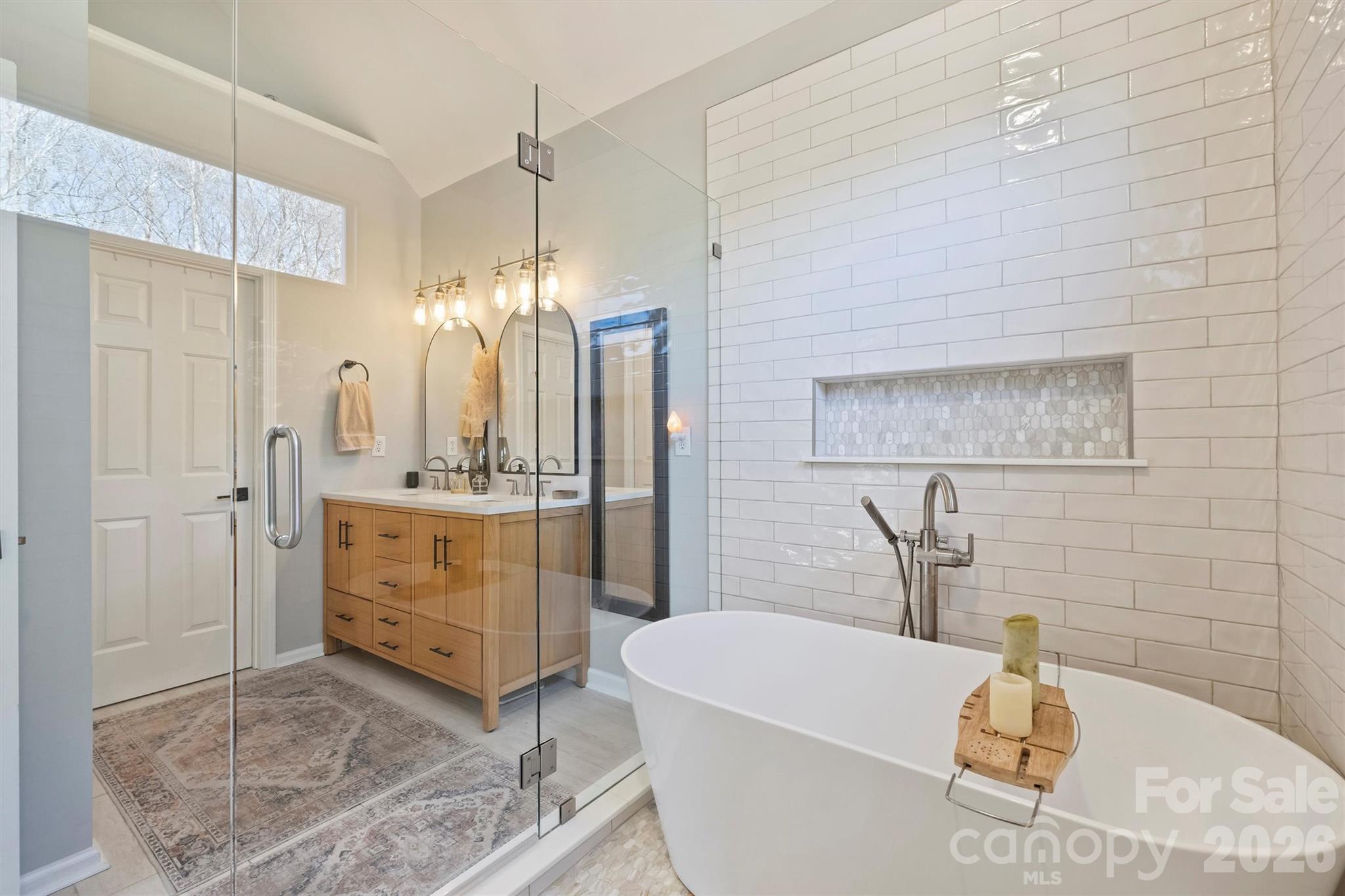 15346 Yarmouth Road Mint Hill, NC 28227 - Photo 25 of 43 a bathroom with a tub a sink a mirror and shower