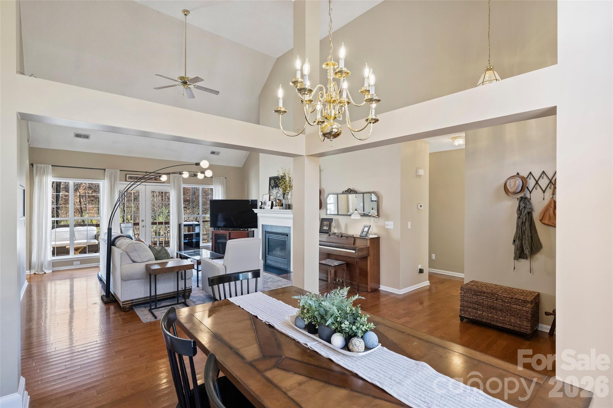 15346 Yarmouth Road Mint Hill, NC 28227 - Photo 6 of 43 a living room with furniture a chandelier a large window and wooden floor