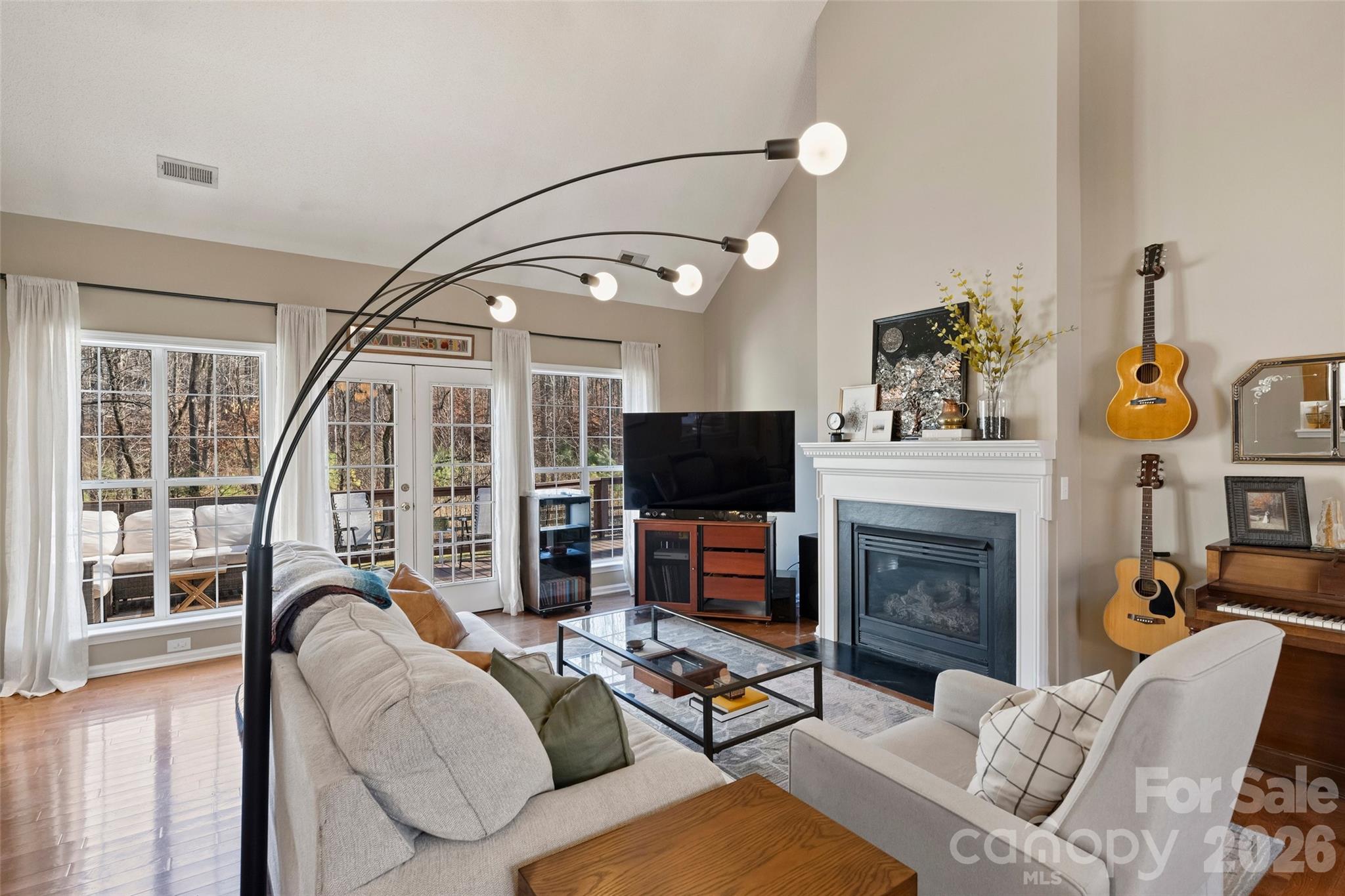 15346 Yarmouth Road Mint Hill, NC 28227 - Photo 9 of 43 a living room with furniture a flat screen tv and a fireplace