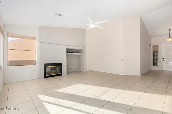 a view of empty room with a fireplace