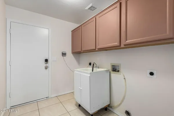 a view of cabinets with washer and dryer
