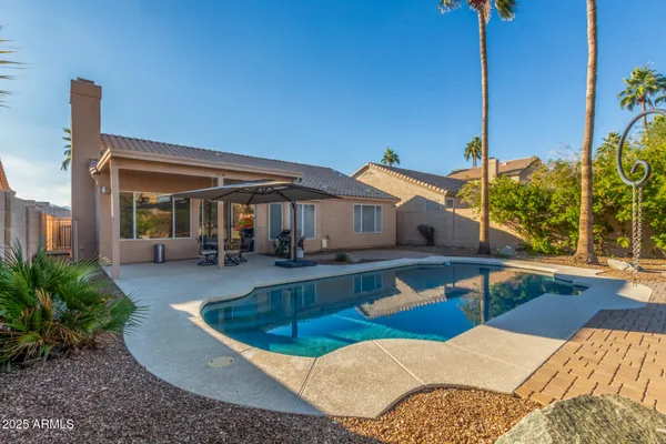 a view of house with swimming pool outdoor seating
