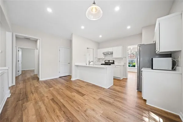 a view of kitchen with cabinets and wooden floor