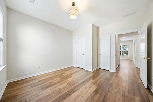 a view of a room with wooden floor