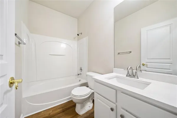 a bathroom with a sink a toilet and bathtub