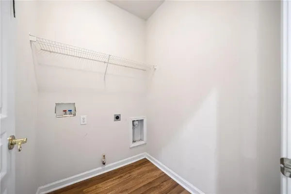 a view of a room with wooden floor