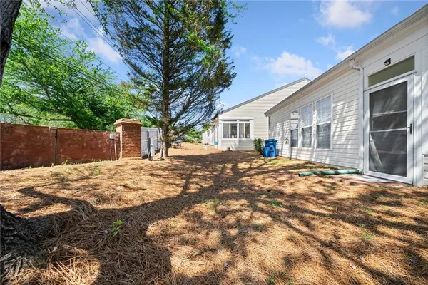 a view of a yard with a large tree