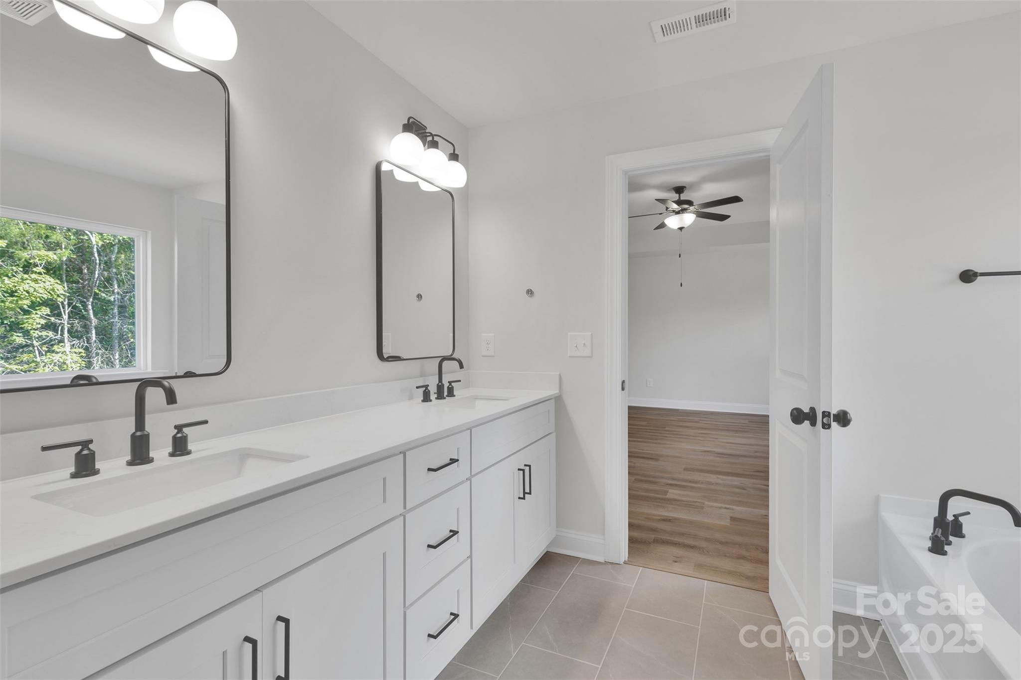 1809 Country Club Road, Unit 3 Lincolnton, NC 28092 - Photo 35 of 43 a bathroom with double vanity sink and a mirror