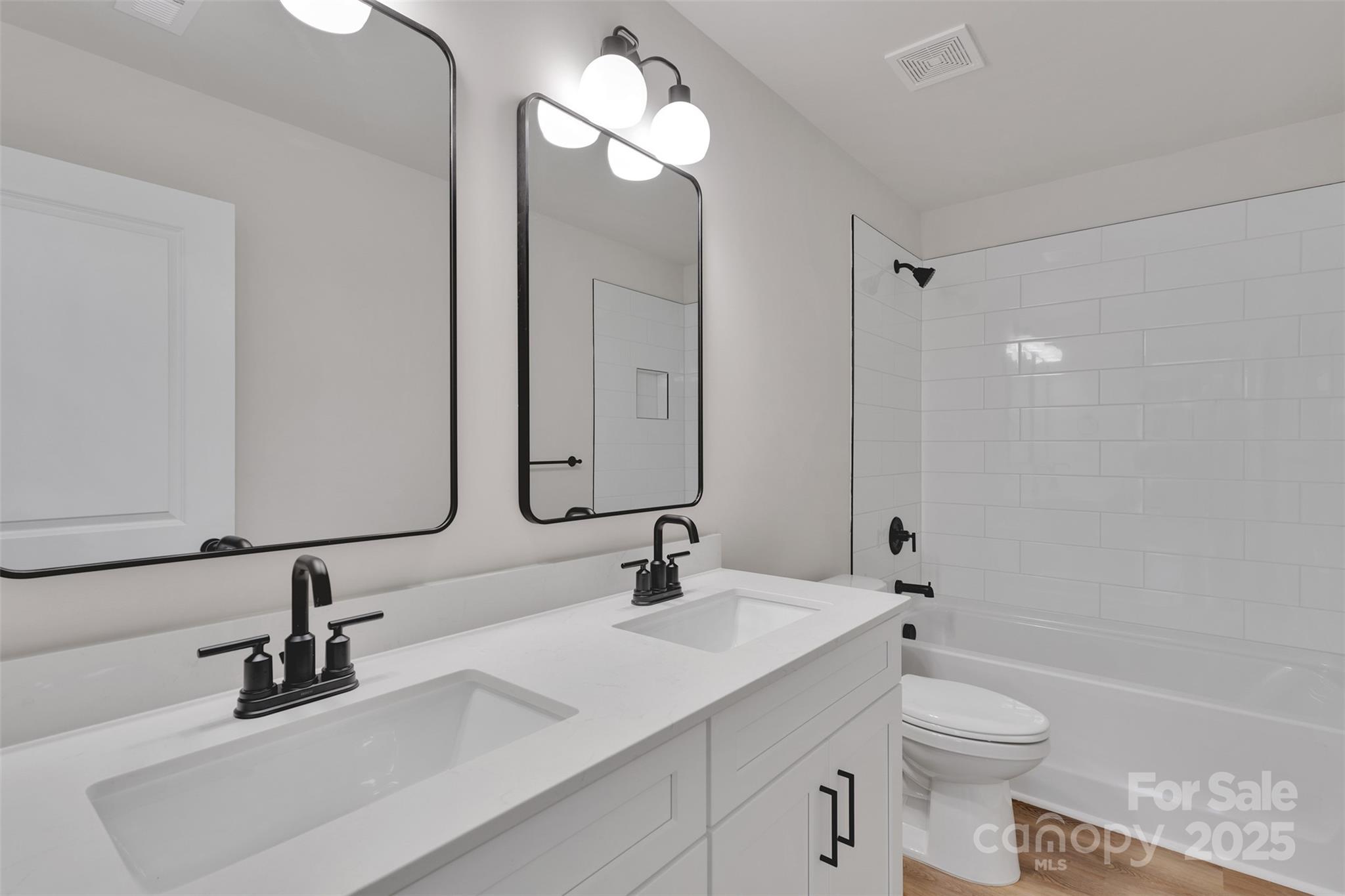 1809 Country Club Road, Unit 3 Lincolnton, NC 28092 - Photo 43 of 43 a bathroom with a double vanity sink toilet and a mirror