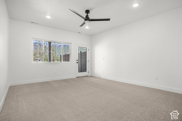 1631 West Century Lane, Unit B Mapleton, UT 84664 - Photo 10 of 23 Primary bedroom- walk out Recessed lighting illuminating a spacious room with light-toned carpeting and a modern ceiling fan