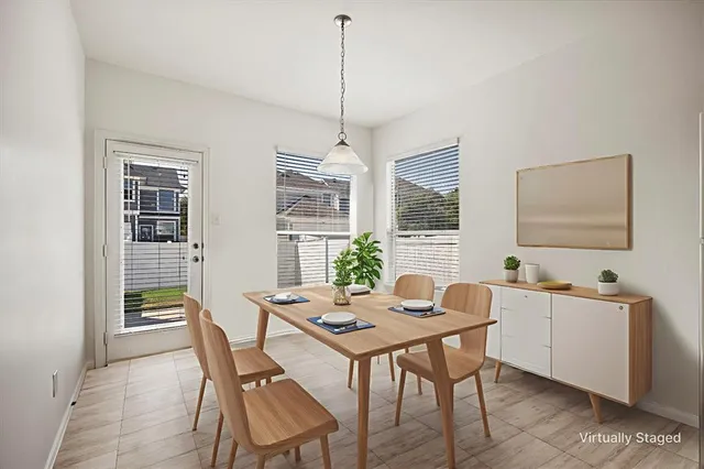 a dining room with furniture and window