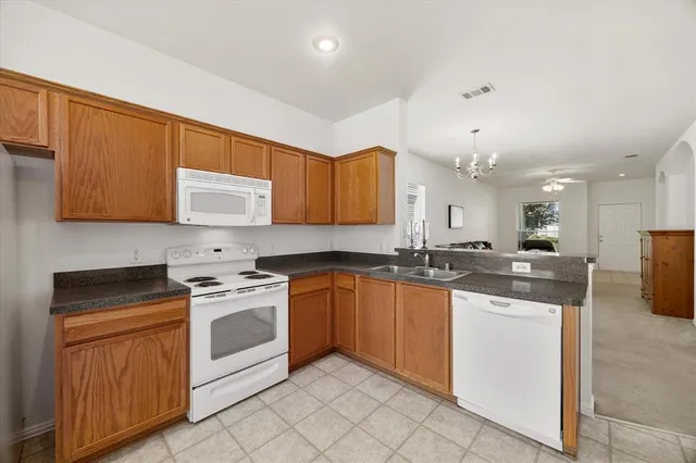 a kitchen with stainless steel appliances granite countertop a sink and cabinets