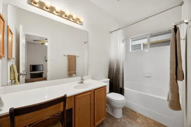 a bathroom with a double vanity sink toilet and shower