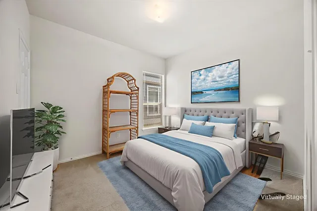 a bedroom with a bed and a potted plant