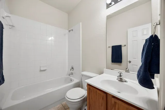 a bathroom with a sink toilet tub and vanity