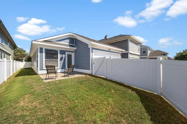 a view of a house with pool and chairs