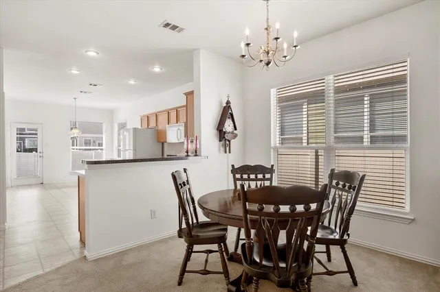 a view of a dining room with furniture and chandelier