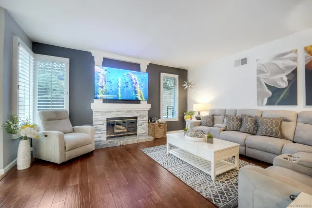 a living room with furniture a fireplace with wooden floor