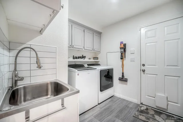 a kitchen with a sink cabinets and stainless steel appliances