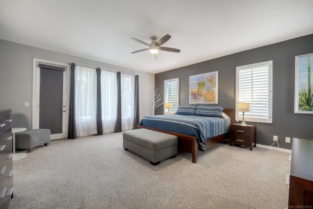 a spacious bedroom with a bed and a chandelier