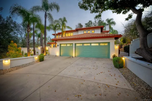 a view of a street with potted plants