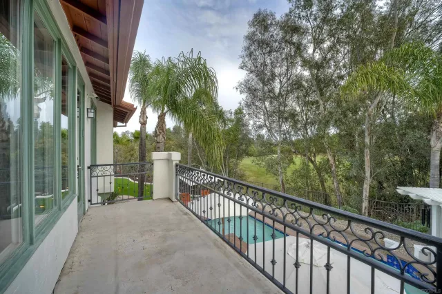 a view of a balcony with trees