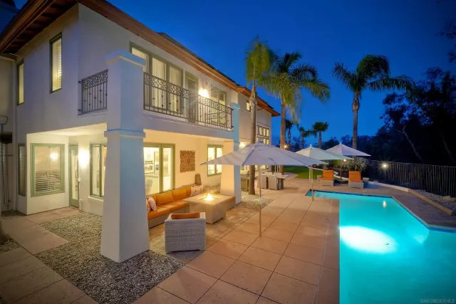 a view of a patio with table and chairs potted plants