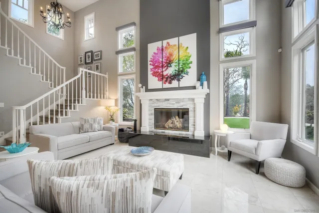 a spacious bedroom with furniture and a fireplace