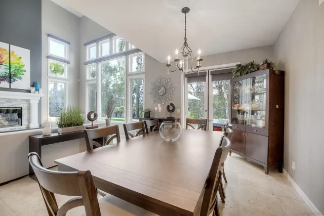 a view of a dining room with furniture large windows and wooden floor