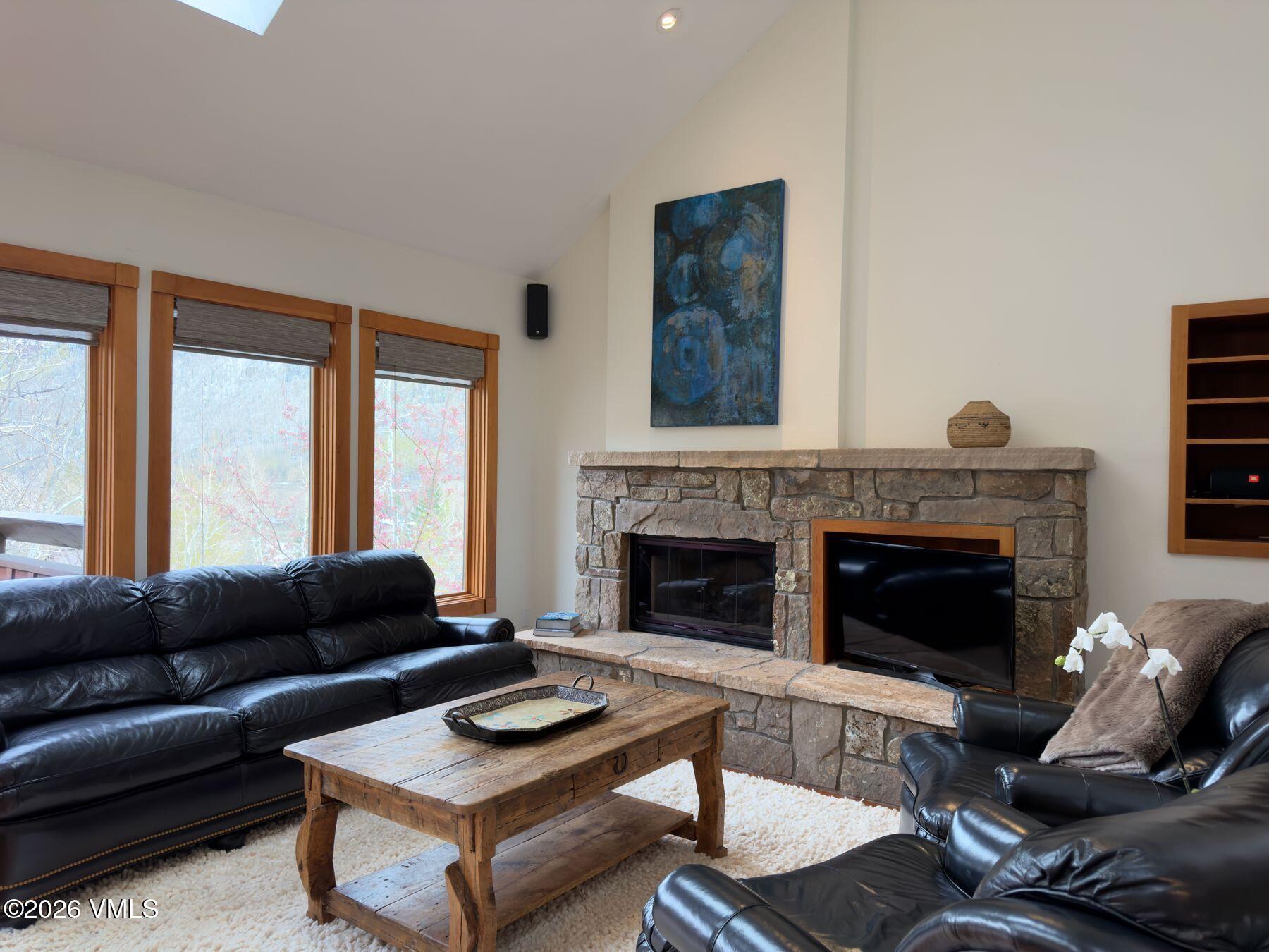 2875 Manns Ranch Road, Unit J2 Vail, CO 81657 - Photo 2 of 25 a living room with furniture and a fireplace