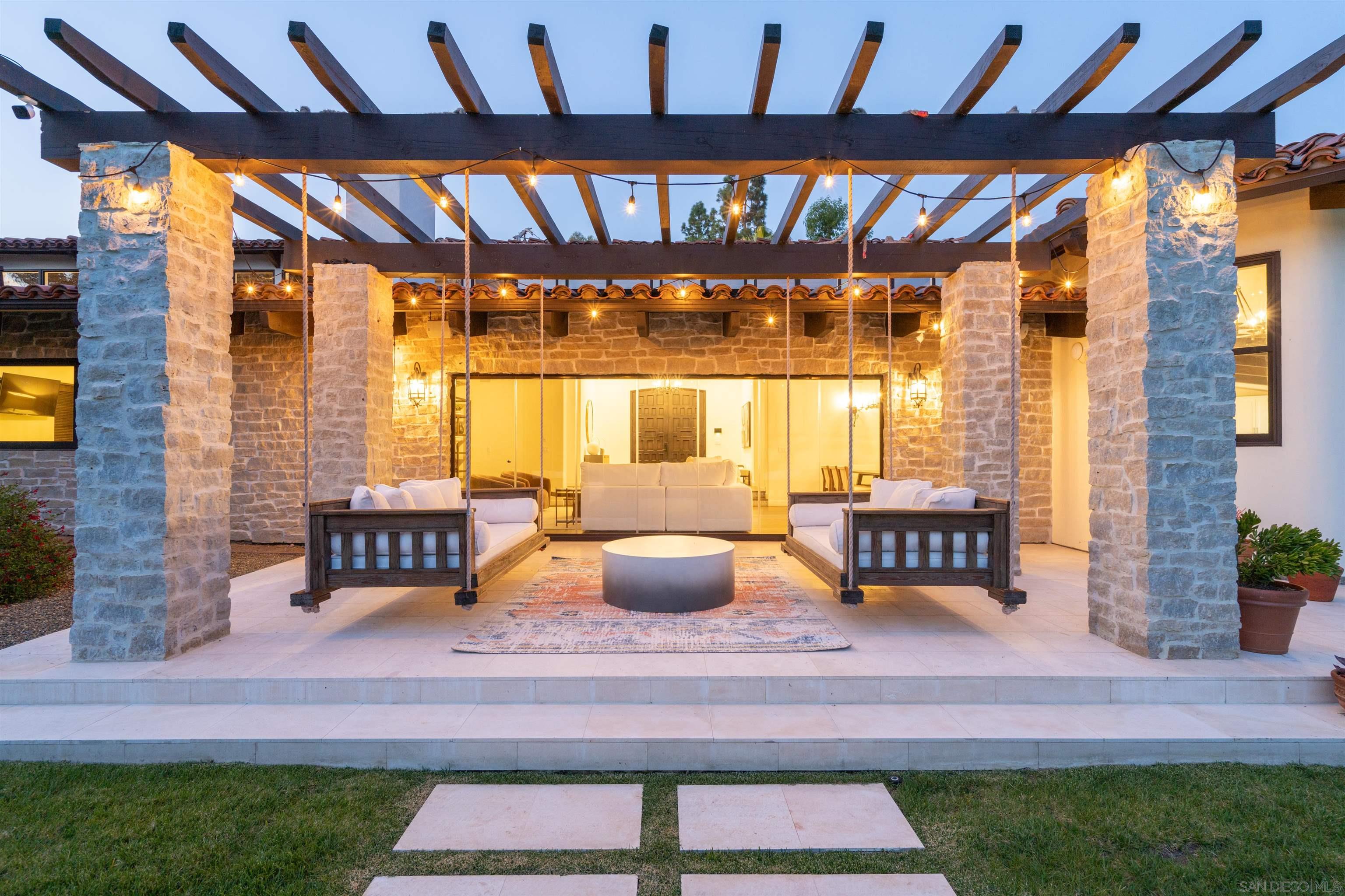 a building outdoor space with patio furniture and potted plants