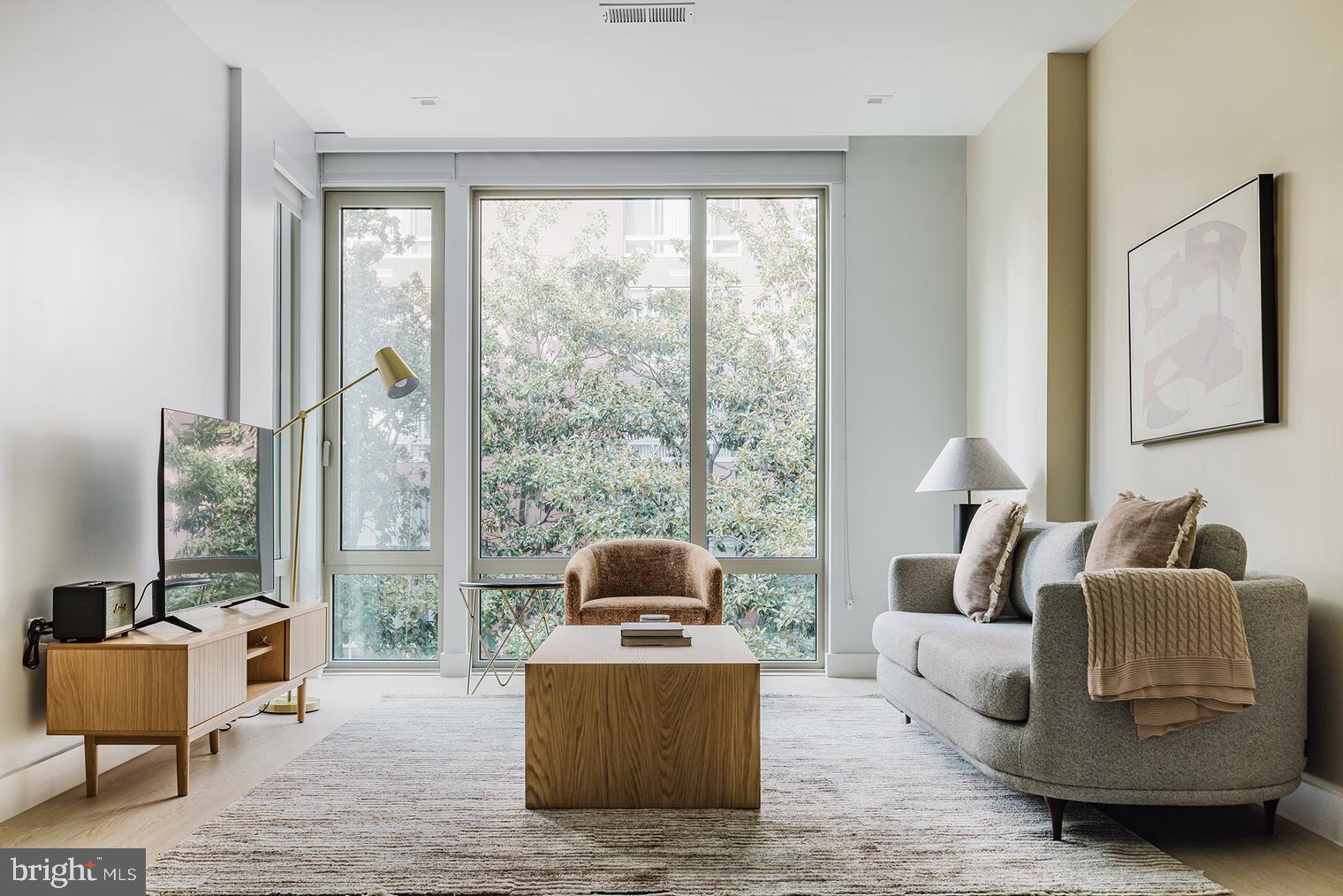 a living room with furniture and a large window