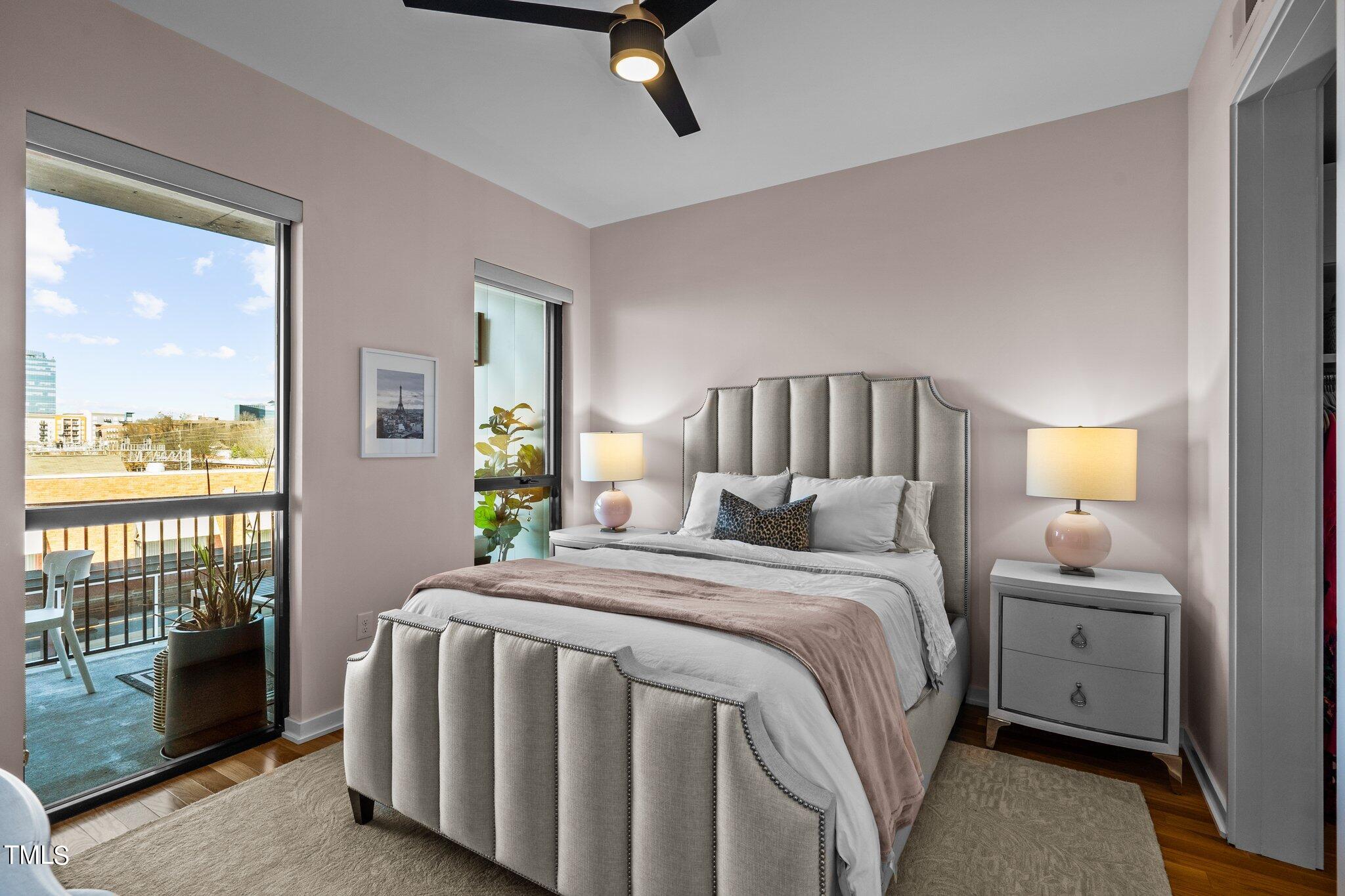 523 South West Street, Unit 304 Raleigh, NC 27601 - Photo 5 of 23 a bedroom with a bed and glass window