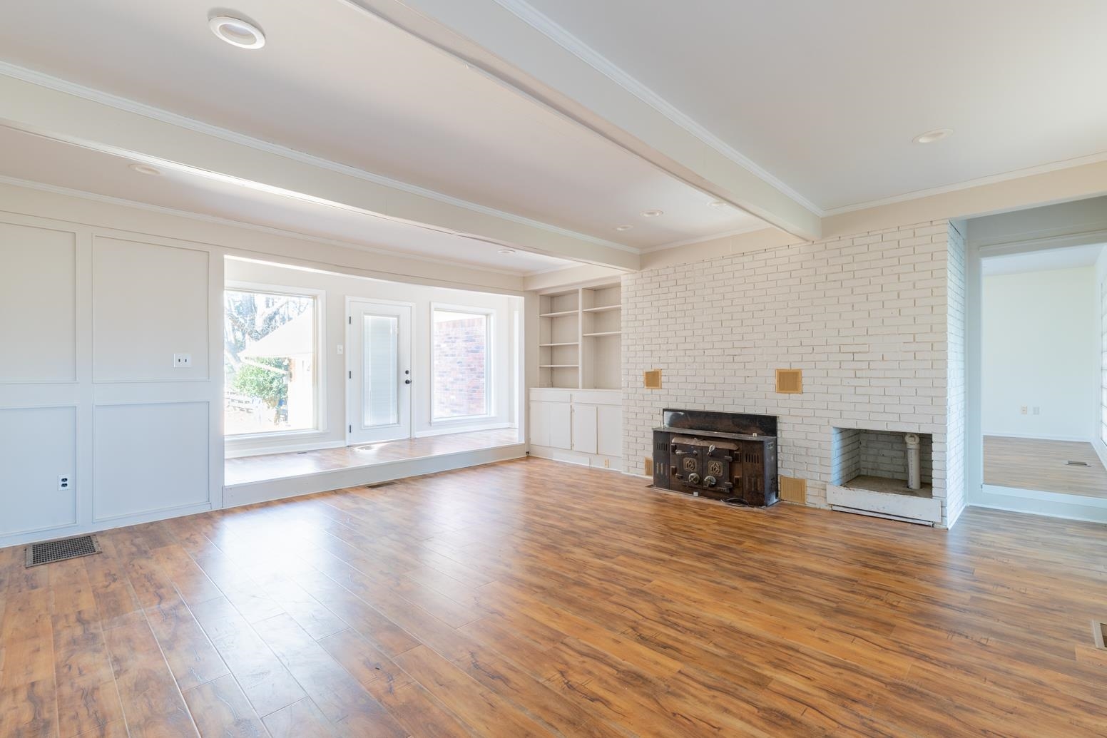 415 Key Road Collierville, TN 38017 - Photo 13 of 40 an empty room with wooden floor fireplace and windows