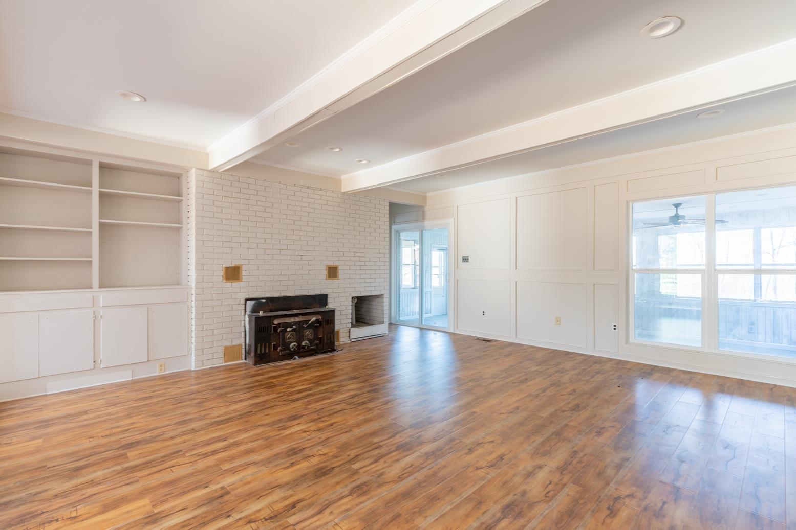 415 Key Road Collierville, TN 38017 - Photo 14 of 40 an empty room with wooden floor fireplace and windows